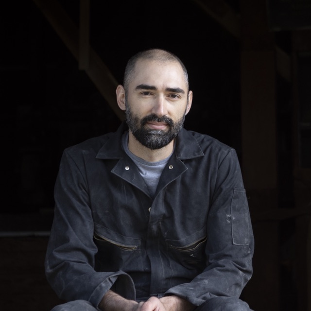 Charlie Wade seated in the doorway of the mill